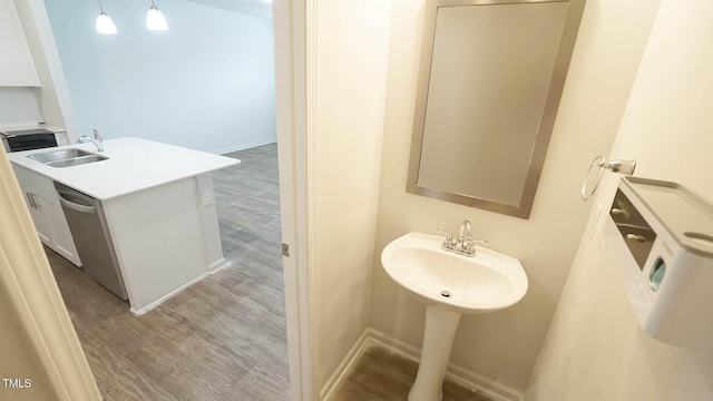 103 Liam St Unit 108, Clayton, NC 27520 - half bathroom featuring a sink and wood finished floors
