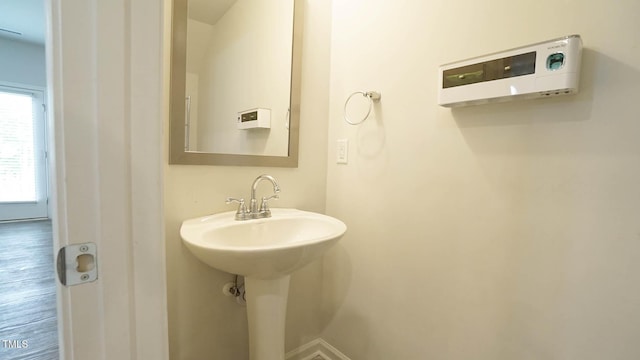 103 Liam St Unit 108, Clayton, NC 27520 - bathroom featuring baseboards and wood finished floors