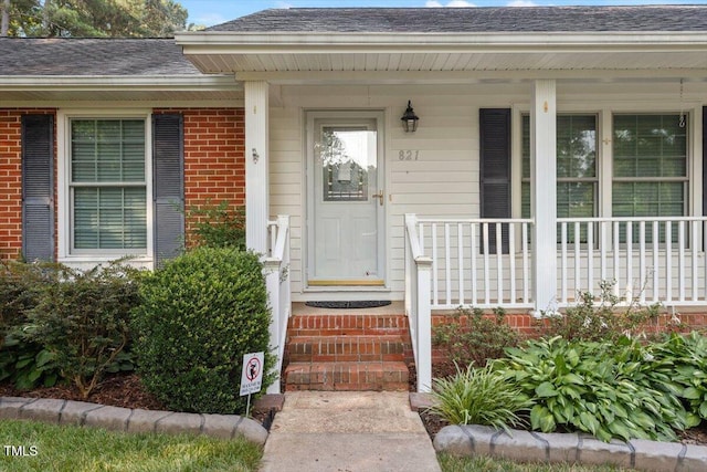 821 Northclift Dr, Raleigh, NC 27609 - entrance to property with brick siding, roof with shingles, and a porch