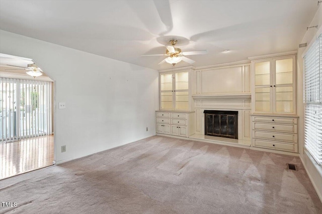 821 Northclift Dr, Raleigh, NC 27609 - unfurnished living room with a ceiling fan, light colored carpet, and healthy amount of natural light