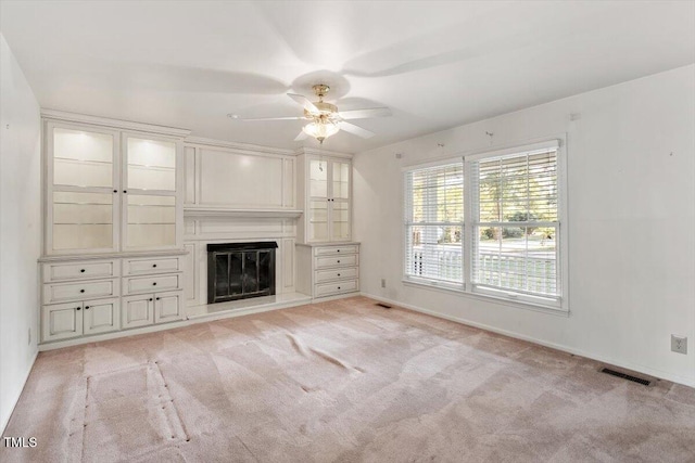 821 Northclift Dr, Raleigh, NC 27609 - unfurnished living room featuring ceiling fan, light carpet, and a glass covered fireplace