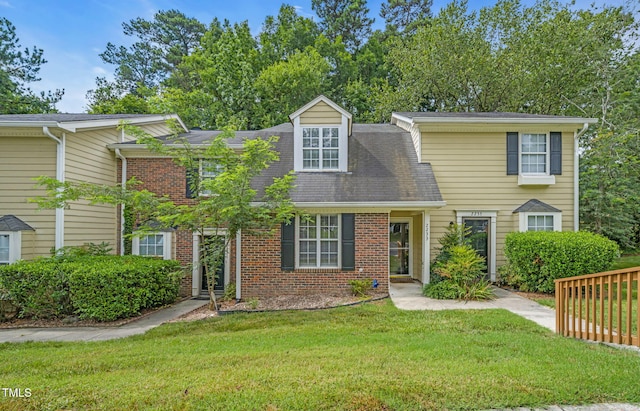 2233 Alpine Rd, Durham, NC 27707 - view of front of house featuring a front yard, brick siding, and roof with shingles