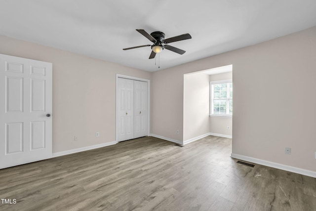 2233 Alpine Rd, Durham, NC 27707 - unfurnished bedroom with wood finished floors, a closet, and ceiling fan