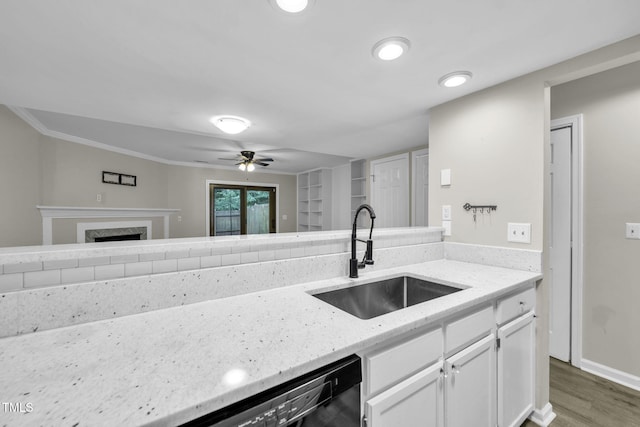 2233 Alpine Rd, Durham, NC 27707 - kitchen featuring white cabinets, light stone countertops, wood finished floors, a ceiling fan, and a fireplace