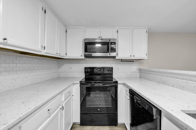 2233 Alpine Rd, Durham, NC 27707 - kitchen with black appliances, light stone countertops, and white cabinetry