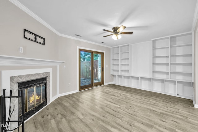 2233 Alpine Rd, Durham, NC 27707 - unfurnished living room featuring a glass covered fireplace, ceiling fan, wood finished floors, ornamental molding, and built in shelves
