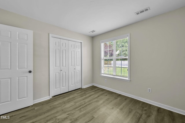 2233 Alpine Rd, Durham, NC 27707 - unfurnished bedroom with wood finished floors and a closet