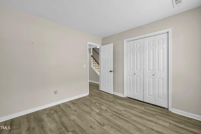 2233 Alpine Rd, Durham, NC 27707 - unfurnished bedroom with wood finished floors and a closet