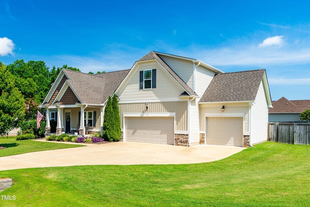 20 Kola Nut, Smithfield, NC 27577 - view of front facade with stone siding, a porch, driveway, roof with shingles, and an attached garage