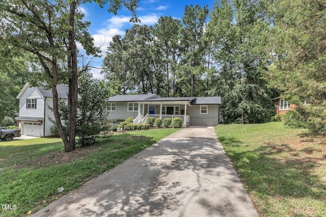 1316 Foxrun Dr, Raleigh, NC 27610 - tri-level home with a porch, concrete driveway, a front lawn, and an attached garage