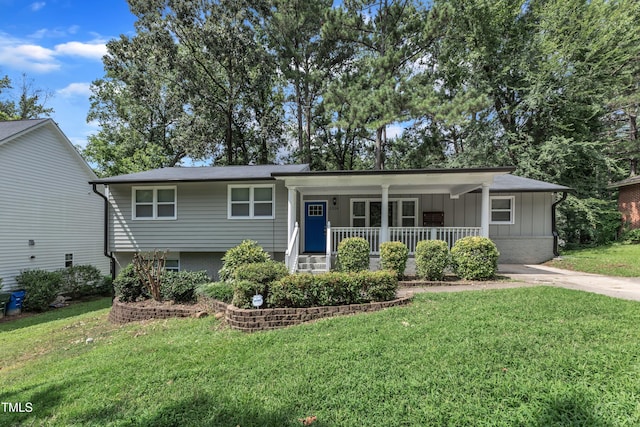 1316 Foxrun Dr, Raleigh, NC 27610 - view of front of house with a porch, a front lawn, board and batten siding, and brick siding