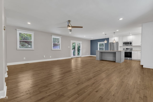 1316 Foxrun Dr, Raleigh, NC 27610 - unfurnished living room with ceiling fan, wood finished floors, and recessed lighting