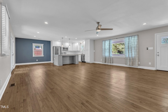 1316 Foxrun Dr, Raleigh, NC 27610 - unfurnished living room with dark wood finished floors, a ceiling fan, and recessed lighting