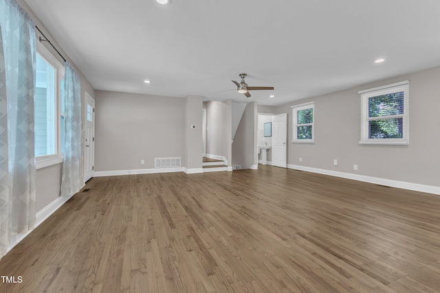 1316 Foxrun Dr, Raleigh, NC 27610 - unfurnished living room featuring light wood-style flooring, recessed lighting, a ceiling fan, and stairs