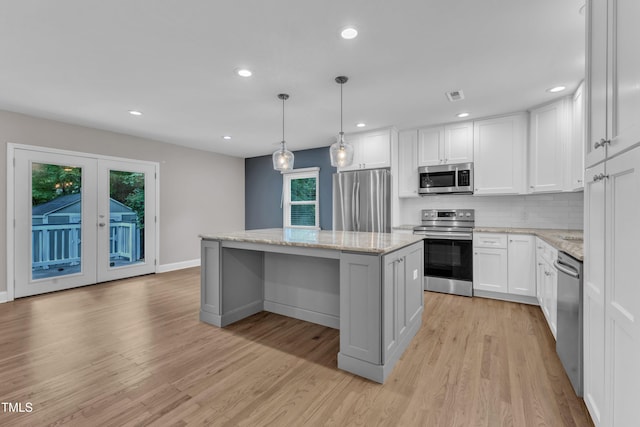1316 Foxrun Dr, Raleigh, NC 27610 - kitchen with stainless steel appliances, a kitchen island, backsplash, healthy amount of natural light, and recessed lighting