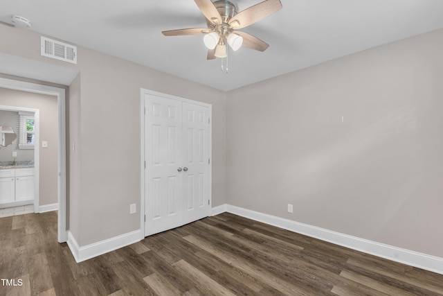 1316 Foxrun Dr, Raleigh, NC 27610 - unfurnished bedroom featuring dark wood-style flooring, a closet, and a ceiling fan