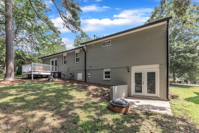 1316 Foxrun Dr, Raleigh, NC 27610 - back of property with brick siding, french doors, a wooden deck, and a lawn