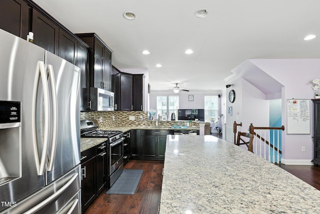 651 Berry Chase Way, Cary, NC 27519 - kitchen with stainless steel appliances, light stone counters, recessed lighting, decorative backsplash, and ceiling fan