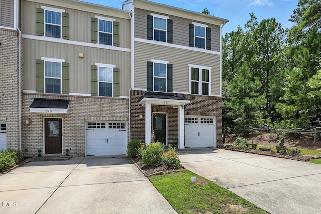 651 Berry Chase Way, Cary, NC 27519 - townhome / multi-family property featuring concrete driveway, a garage, and brick siding
