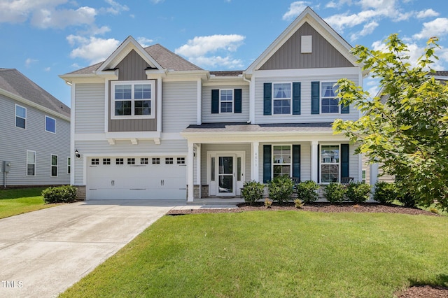 4611 Lazy Hollow Dr, Knightdale, NC 27545 - view of front of property with board and batten siding, a front yard, concrete driveway, and a garage