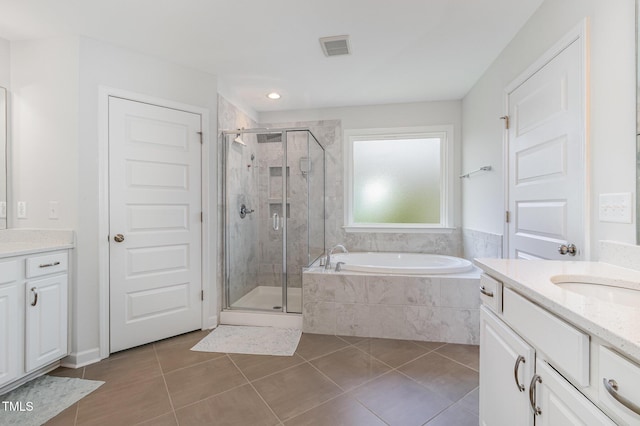 4611 Lazy Hollow Dr, Knightdale, NC 27545 - full bathroom with vanity, tile patterned floors, a garden tub, and a shower stall
