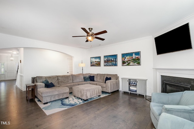 4611 Lazy Hollow Dr, Knightdale, NC 27545 - living area featuring arched walkways, dark wood finished floors, crown molding, a ceiling fan, and a fireplace