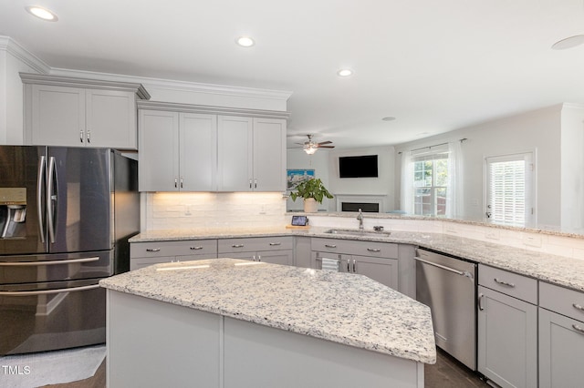 4611 Lazy Hollow Dr, Knightdale, NC 27545 - kitchen with appliances with stainless steel finishes, gray cabinets, a ceiling fan, crown molding, and recessed lighting