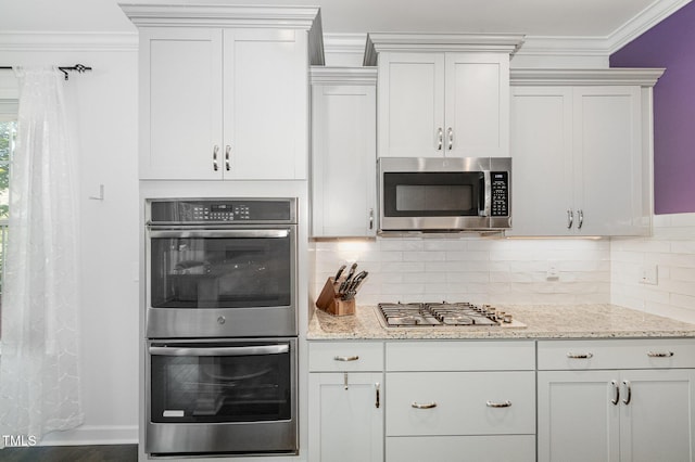 4611 Lazy Hollow Dr, Knightdale, NC 27545 - kitchen featuring appliances with stainless steel finishes, ornamental molding, decorative backsplash, light stone countertops, and wood finished floors