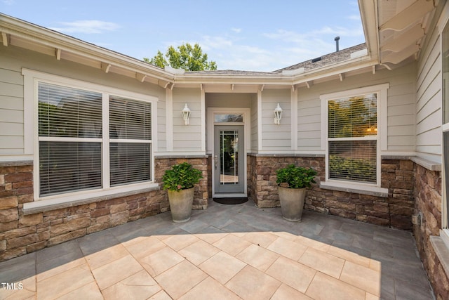 501 Tranquil Sound Dr, Cary, NC 27519 - view of exterior entry with a patio and stone siding