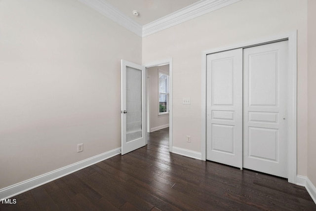 501 Tranquil Sound Dr, Cary, NC 27519 - unfurnished bedroom featuring dark wood-type flooring, crown molding, and a closet