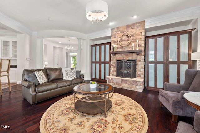 501 Tranquil Sound Dr, Cary, NC 27519 - living room with decorative columns, wood-type flooring, a fireplace, a chandelier, and crown molding