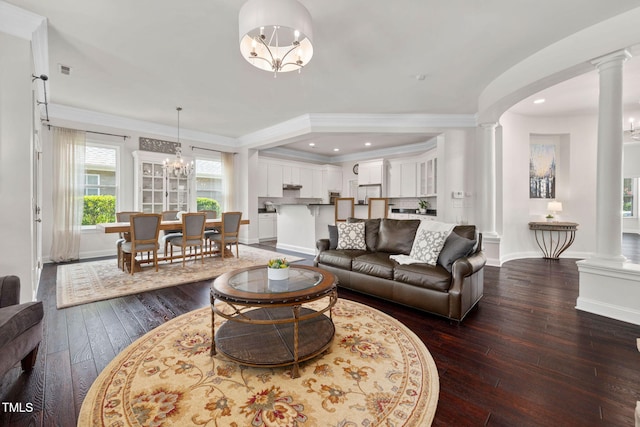 501 Tranquil Sound Dr, Cary, NC 27519 - living room with decorative columns, dark wood finished floors, a chandelier, ornamental molding, and recessed lighting