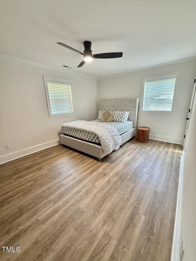 41 Lakewood Dr, Roxboro, NC 27573 - bedroom with ornamental molding, multiple windows, wood finished floors, and a ceiling fan