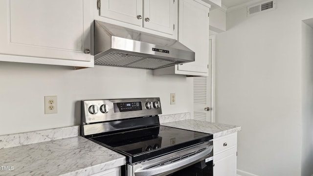 550 Pine Ridge Pl, Raleigh, NC 27609 - kitchen with electric range, under cabinet range hood, light countertops, and white cabinetry