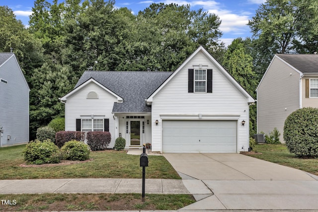 5513 Enoree Ln, Raleigh, NC 27616 - traditional-style home with driveway, a shingled roof, a front lawn, and an attached garage