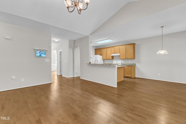 5513 Enoree Ln, Raleigh, NC 27616 - unfurnished living room featuring a chandelier, wood finished floors, high vaulted ceiling, and arched walkways