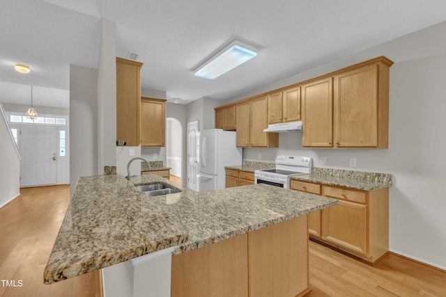 5513 Enoree Ln, Raleigh, NC 27616 - kitchen featuring white appliances, under cabinet range hood, a peninsula, light wood-type flooring, and light stone counters