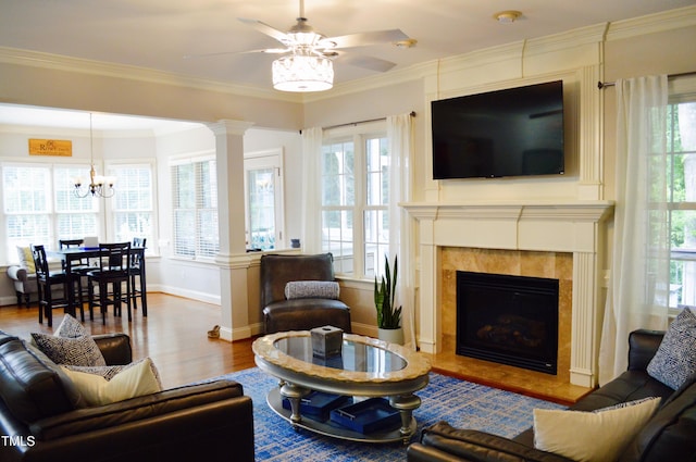 114 Bridle Path, Pittsboro, NC 27312 - living area with plenty of natural light, wood finished floors, a chandelier, ceiling fan, and ornamental molding