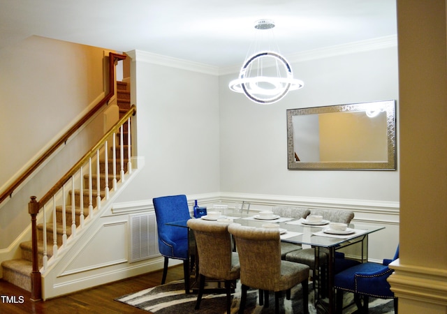 114 Bridle Path, Pittsboro, NC 27312 - dining space with a chandelier, stairway, wood finished floors, ornamental molding, and a wainscoted wall