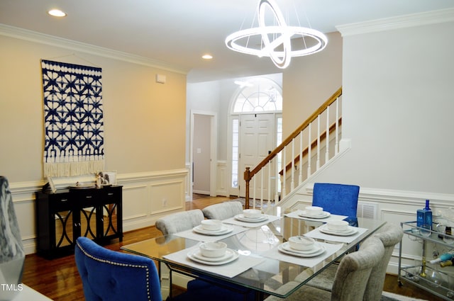 114 Bridle Path, Pittsboro, NC 27312 - dining space with a chandelier, stairs, wood finished floors, ornamental molding, and wainscoting