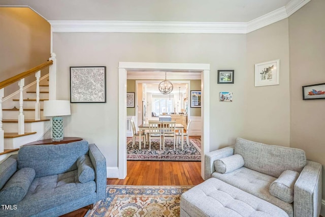 1213 Pierce St, Raleigh, NC 27605 - living area with crown molding, a chandelier, stairs, and wood finished floors