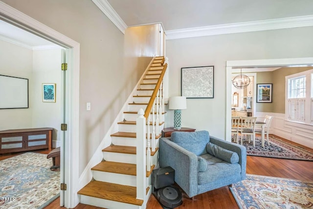 1213 Pierce St, Raleigh, NC 27605 - staircase featuring wood finished floors, a chandelier, and crown molding