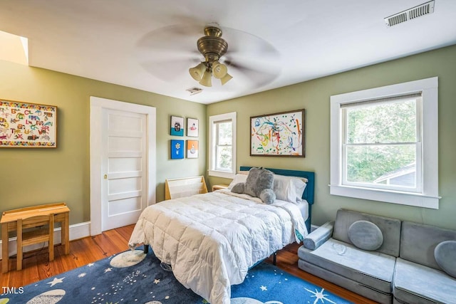 1213 Pierce St, Raleigh, NC 27605 - bedroom with wood finished floors and ceiling fan