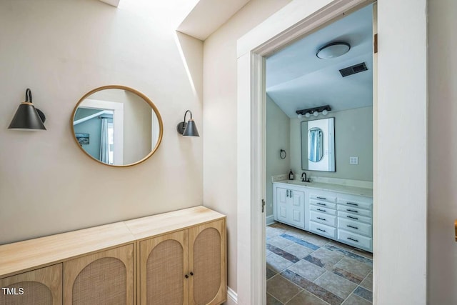 1213 Pierce St, Raleigh, NC 27605 - bathroom with vanity and stone finish floors