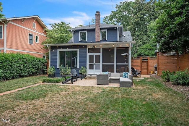 1213 Pierce St, Raleigh, NC 27605 - back of house with a chimney, a patio area, a sunroom, a fenced backyard, and a shingled roof