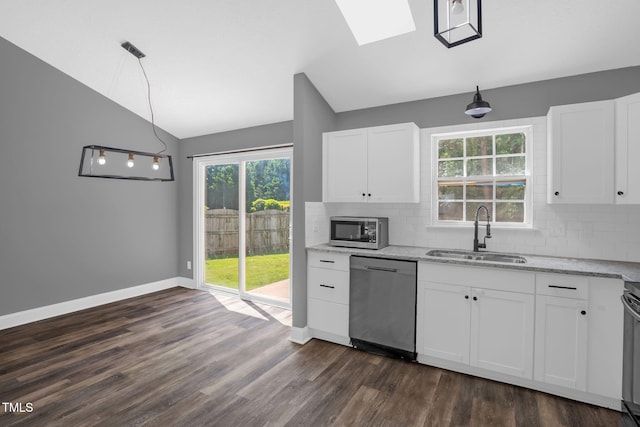 1814 Shiva Ct, Durham, NC 27703 - kitchen featuring stainless steel appliances, vaulted ceiling, dark wood-style floors, backsplash, and light stone counters