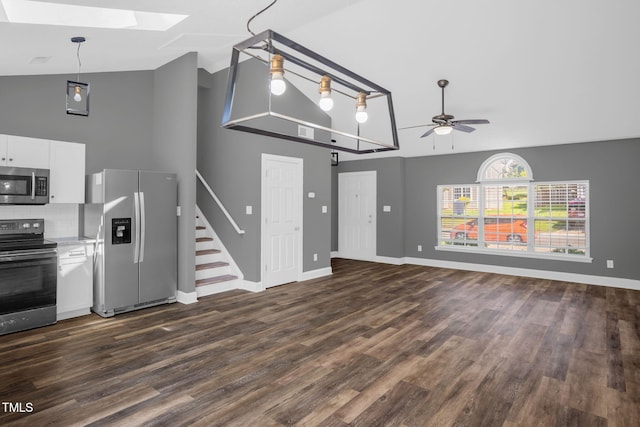 1814 Shiva Ct, Durham, NC 27703 - unfurnished living room featuring a skylight, high vaulted ceiling, a ceiling fan, dark wood-type flooring, and stairway