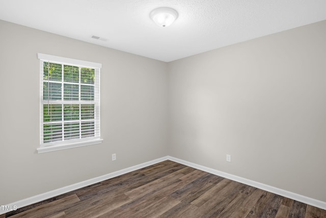 1814 Shiva Ct, Durham, NC 27703 - spare room featuring dark wood-type flooring and baseboards