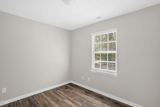 1814 Shiva Ct, Durham, NC 27703 - empty room with dark wood-style floors and baseboards