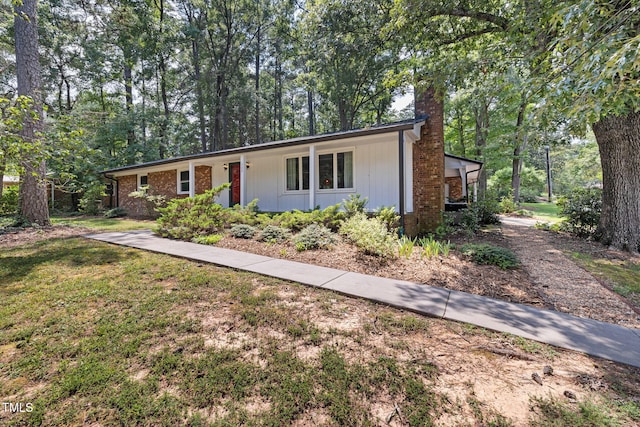 700 Tinkerbell Rd, Chapel Hill, NC 27517 - ranch-style house with a chimney, a front lawn, a porch, and brick siding